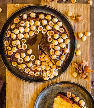 Pumpkin cheesecake with cranberries, caramel, and hazelnuts