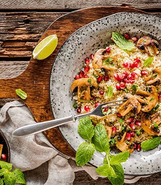 Warm couscous with citrus mushrooms and pomegranate
