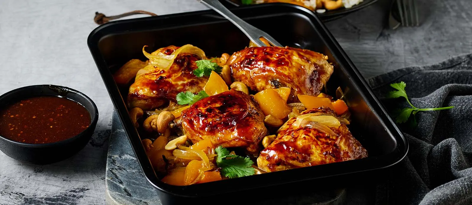 Garlicky Glazed Chicken Thighs baked with Cashews and Peppers