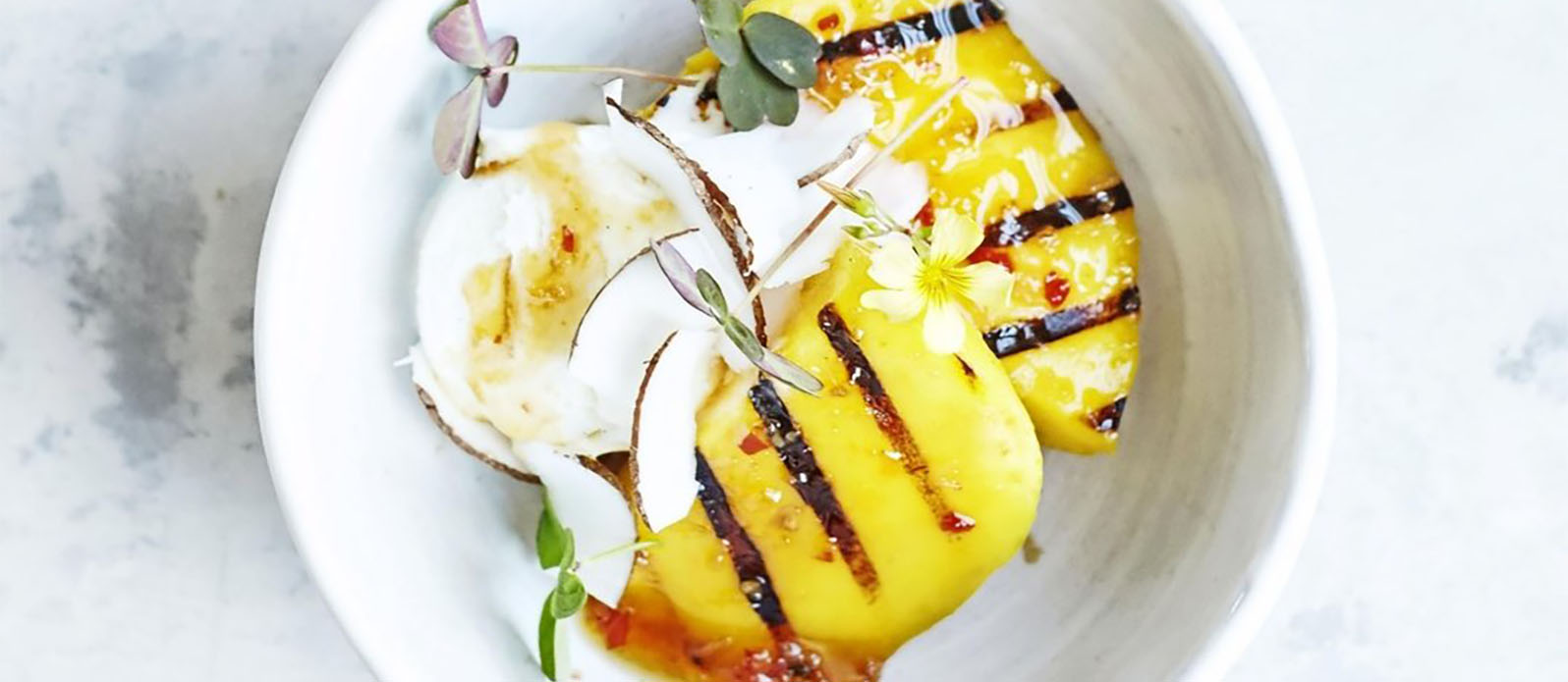Grilled mango with Ponzu syrup, ice cream and coconut flakes Kikkoman